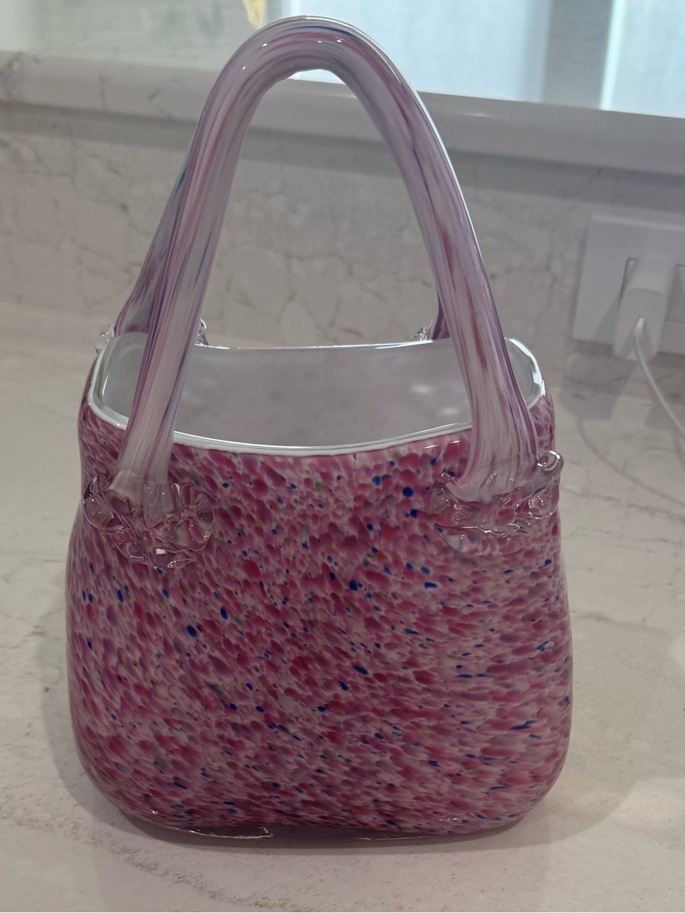 This is a hand-blown art glass purse vase featuring a pink confetti